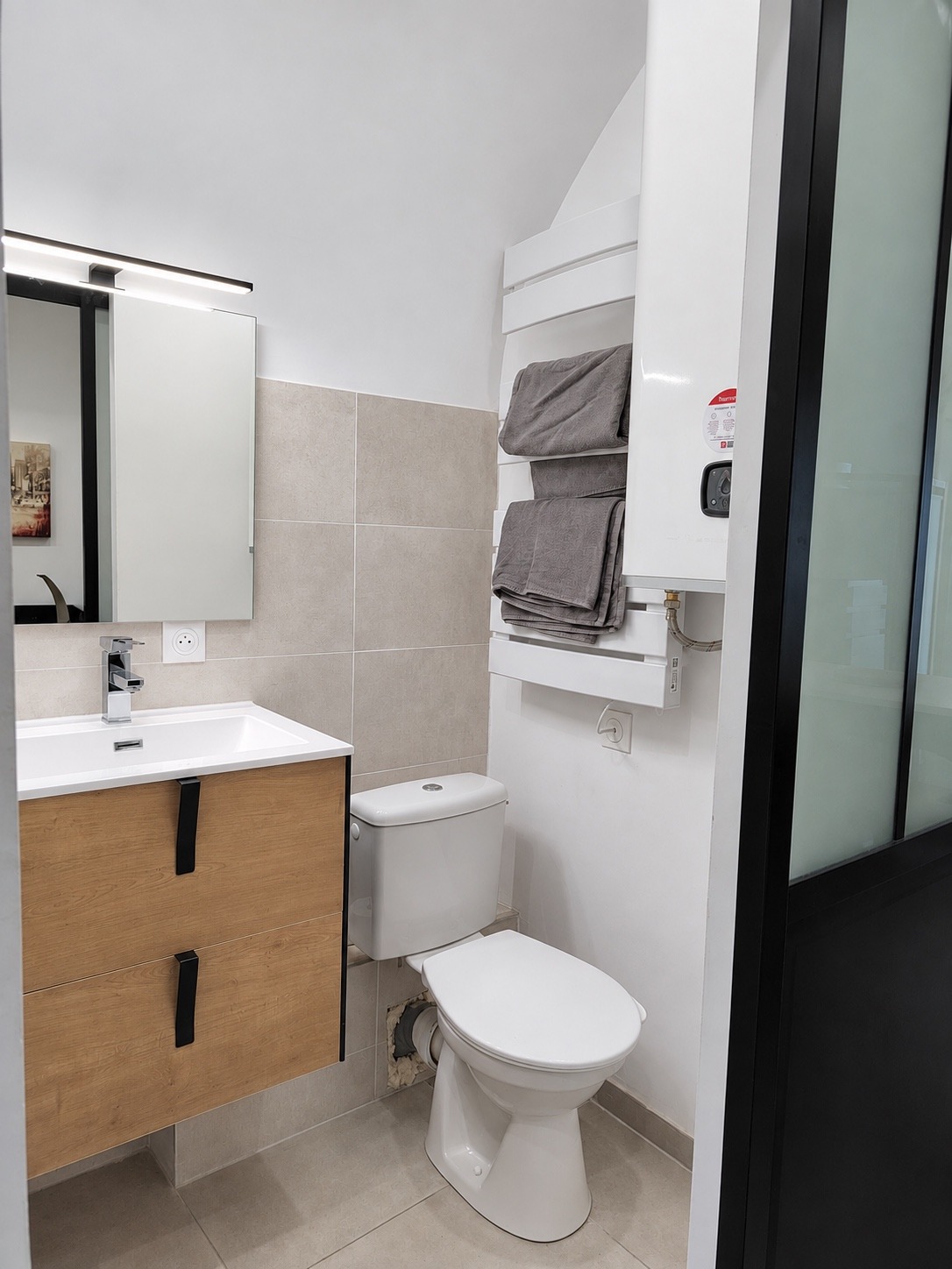 Salle d’eau du studio avec toilettes et sèche-serviettes